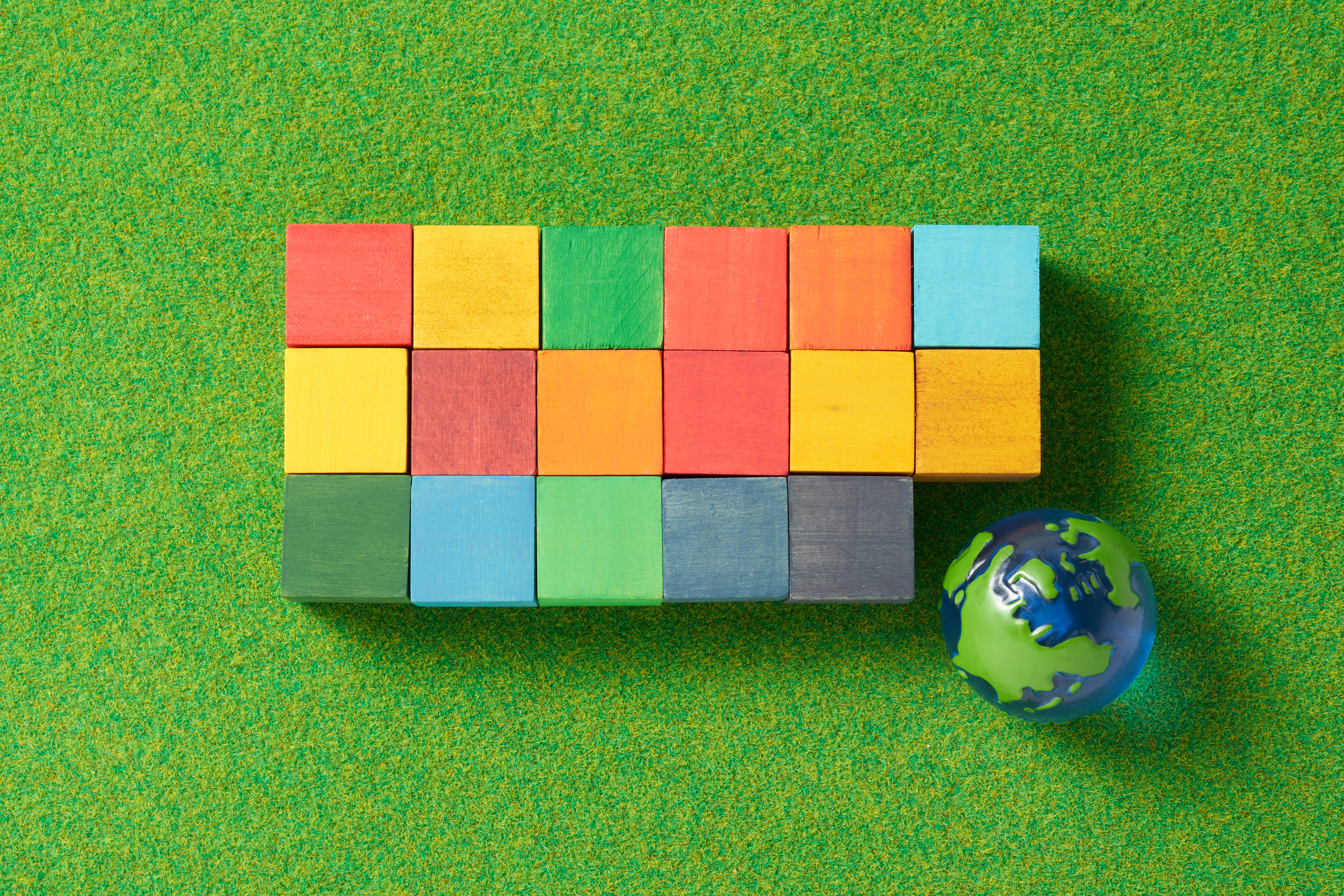 globe and a wooden cube stamped with the letters SDGs.